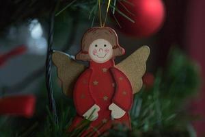 um anjo de madeira em uma árvore de natal foto