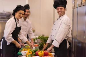 cozinheiros e chefs de equipe preparando a refeição foto