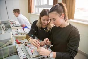 alunos fazendo prática na sala de aula eletrônica foto