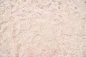 closeup abstrato de textura de padrão de areia de uma praia no verão - filtro vintage foto