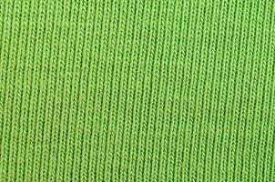 a textura do tecido é verde brilhante. material para fazer camisas e blusas foto