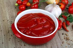 ketchup de tomate na madeira foto