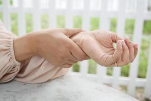 mãos de mulheres jovens sofrendo dor no pulso foto