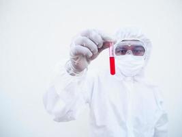 médico asiático ou cientista em uniforme de suíte de EPI. equipamento de proteção individual segurando o teste do tubo de sangue. coronavírus ou covid-19 conceito isolado fundo branco foto