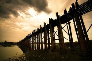 u bein bridge, a ponte de madeira de teca mais antiga e mais longa do mundo que atravessa o lago taungthaman perto de amarapura, myanmar foto