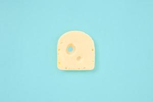 pedaço de queijo no fundo de cor azul foto