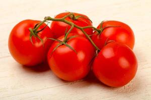 ramo de tomate em fundo de madeira foto