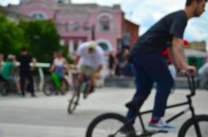 imagem desfocada de muitas pessoas com bicicletas bmx. encontro de fãs de esportes radicais foto