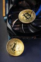 moeda bitcoin em uma placa gráfica poderosa para mineração e ganhar conceito de criptomoeda em um fundo escuro. foto