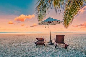 praia incrível. cadeiras no mar da praia de areia. estância de férias de verão de luxo como design de turismo. paisagem tropical panorâmica. cenário tranquilo, praia relaxante, panorama do paraíso do casal romântico foto