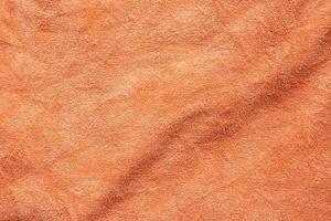 superfície de textura de tecido de toalha laranja fechar fundo foto