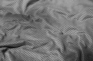 fundo de textura de tecido de roupas esportivas, vista superior da superfície têxtil de pano cinza foto