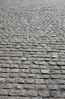a textura de becos de rua na forma de um mosaico feito de pedras de pavimentação processadas à luz do sol foto