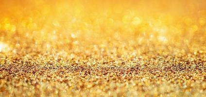 brilho de glitter dourado abstrato com fundo bokeh foto