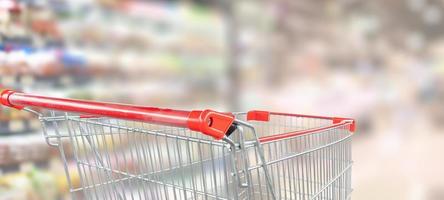 carrinho de compras vermelho vazio no corredor do supermercado foto