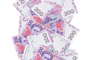 200 contas de hryvnias ucranianas voando para baixo isoladas em branco. muitas notas caindo com copyspace branco no lado esquerdo e direito foto