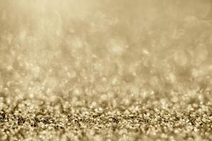 brilho de glitter dourado abstrato turva com fundo bokeh foto
