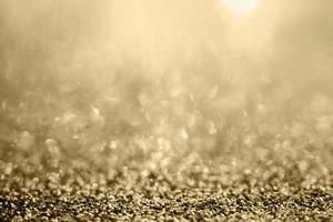 brilho de glitter dourado abstrato turva com fundo bokeh foto