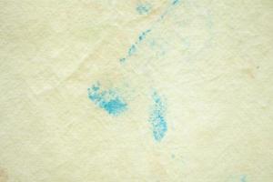 mancha de cor suja no fundo de textura de tecido amarelo foto