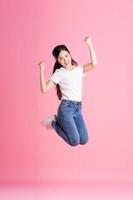 imagem de corpo inteiro de menina asiática posando em fundo rosa foto