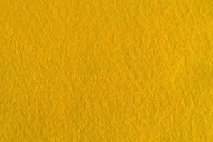 textura natural de feltro amarelo para segundo plano. foto