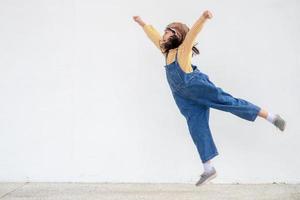 uma menina bonitinha vestida com um boné e óculos de um piloto. a criança sonha em ser piloto. foto