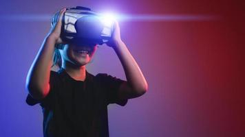 garota feliz em copos de realidade virtual. realidade aumentada, ciência, conceito de tecnologia do futuro. vr. óculos 3d futuristas com projeção virtual. luz neon.