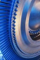 o disco do rotor com as lâminas de um motor de turbina a gás turbojato com um brilho azul. foto