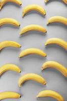 padrão geométrico de bananas amarelas em um fundo cinza nas cores da moda de 2021. foto