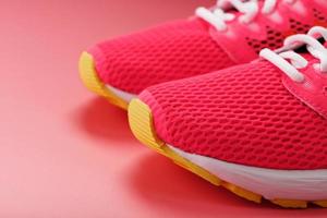 jogging tênis rosa em um fundo rosa com espaço livre. foto
