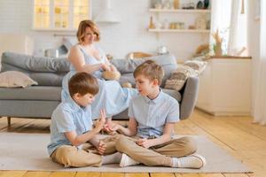 mãe feliz está relaxando no sofá em uma confortável sala de estar brilhante enquanto foto