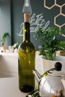 garrafa de vinho verde de vidro com luzes led na decoração da cozinha ou sala de jantar foto