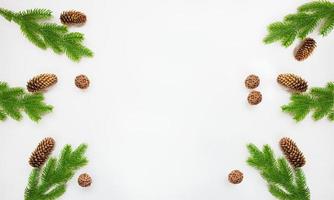 ramos de abeto com pinhas e bolas trançadas em um fundo branco. natal, ano novo. espaço de cópia foto