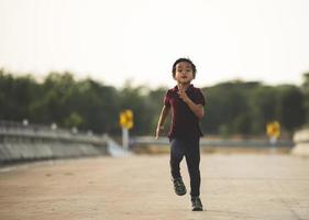 um menino corre ao longo da ponte. foto