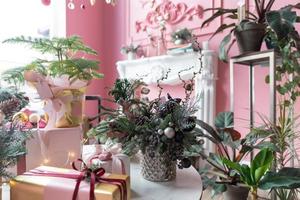 composições elegantes de ano novo de agulhas de abeto naturais em primeiro plano em um elegante interior rosa foto