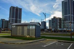 casa elétrica com linhas de energia. casa de concreto com isolamento e ar condicionado para blindagens de eletricidade. no contexto das casas de vidro de um novo complexo residencial foto