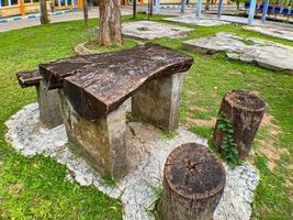cadeiras e mesas feitas de peças de madeira no jardim do hospital foto