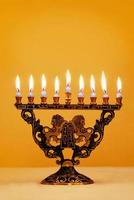 velas de hanukkah iluminadas em menorá de leão foto