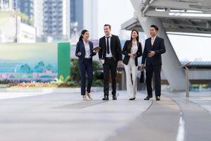 empresários andando e conversando uns com os outros na frente do escritório moderno foto