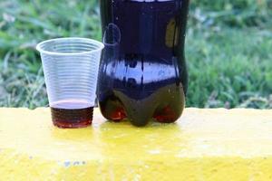 um refrigerante não alcoólico é derramado em um copo. foto