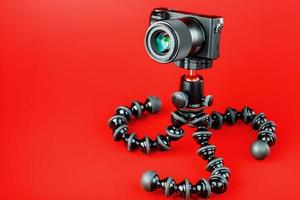 câmera profissional em um tripé, em um fundo vermelho. gravar vídeos e fotos para seu blog, reportagem