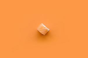 Filadélfia rolo com salmão em fundo laranja. minimalismo vista superior plana lay com comida japonesa foto