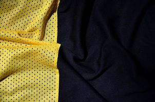 fundo de textura de tecido de roupas esportivas, vista superior da superfície têxtil de pano amarelo foto