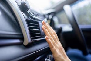 close-up das mãos verificando o ar condicionado do carro, sistema de refrigeração do carro. foto