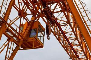 construção de suporte de carga de ferro de metal amarelo pesado estacionário guindaste de pórtico poderoso industrial do tipo ponte em suportes para elevação de carga em um canteiro de obras moderno de edifícios e casas foto