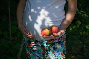 mulher grávida com maçãs frescas. conceito de gravidez, saúde, comida e felicidade. gravidez saudável. foto