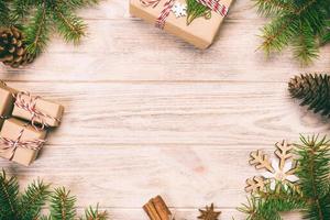 fundo de natal com árvore do abeto e caixa de presente na mesa de madeira. vista superior vintage, em tons com espaço de cópia para seu projeto foto