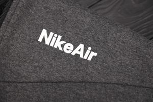 carcóvia. ucrânia - 2 de maio de 2022 logotipo da nike air no fragmento de roupas esportivas cinza. nike é uma empresa multinacional americana envolvida na fabricação e comercialização mundial de roupas e calçados foto