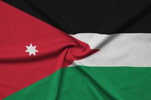 A bandeira da Jordânia é retratada em um tecido esportivo com muitas dobras. bandeira da equipe esportiva foto