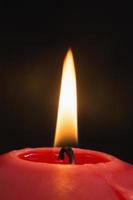 close up de uma vela vermelha acesa